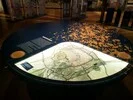 Runder Ausstellungstisch mit kreisförmigen Display, das sich im Innenbereich befindet und Teil der Ausstellung.